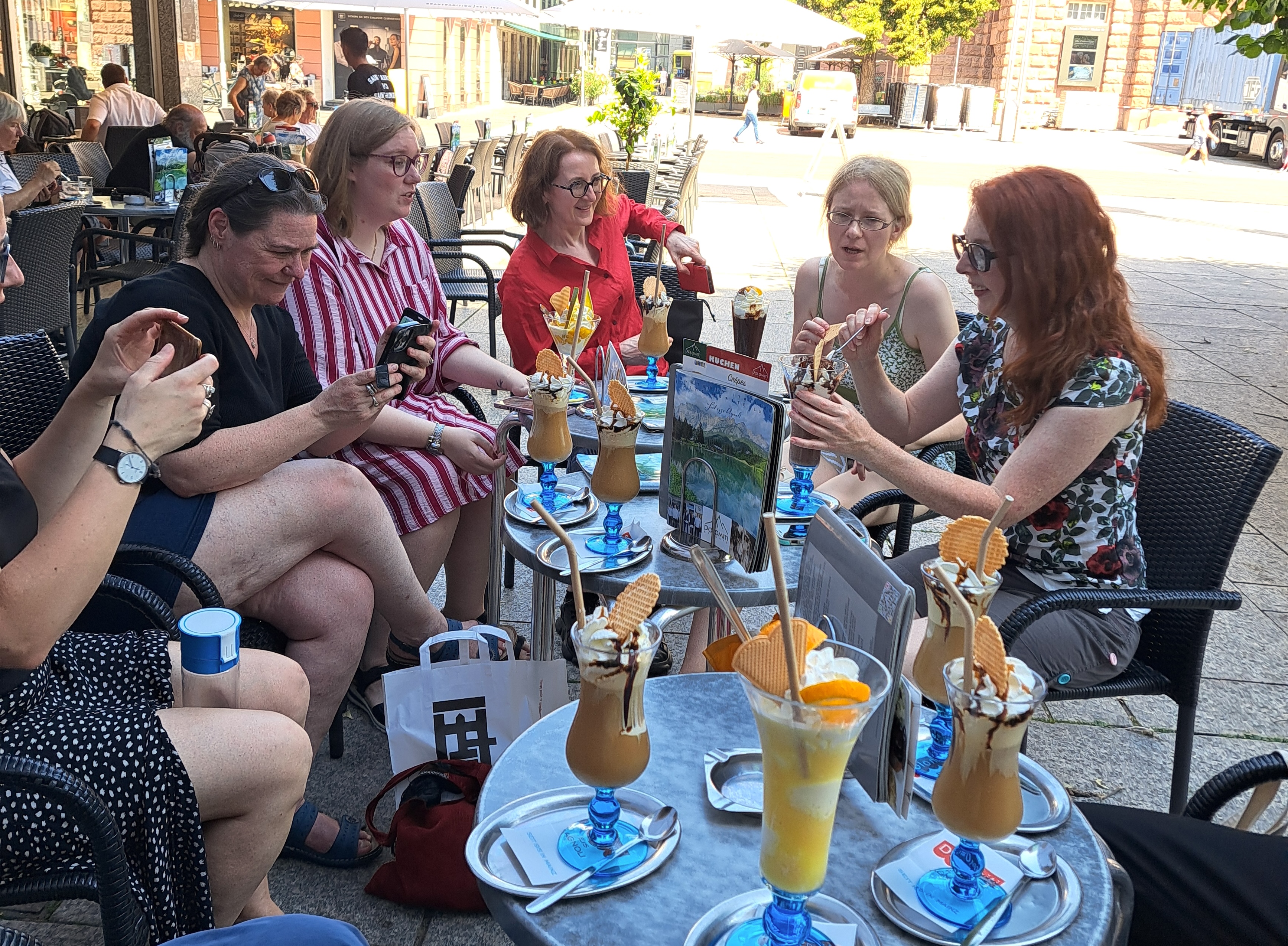 Half a dozen academics sitting around patio tables with lots of ice cream